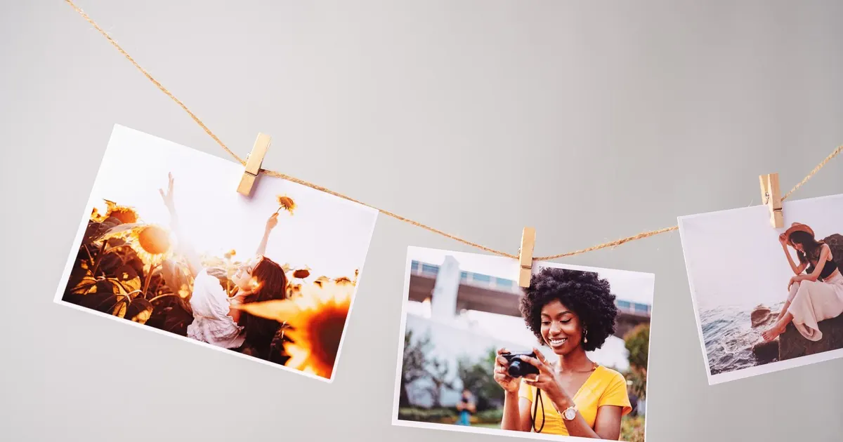 Three printed lifestyle photographs pegged to a length of twine with wooden clips against a grey wall