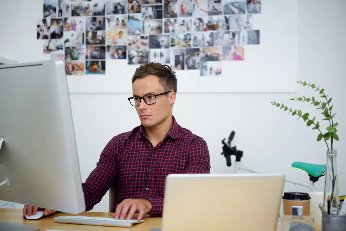 Designer working on a laptop at a creative office desk